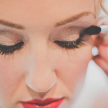 Classic bridal makeup with red lip; defined eyes, flawless skin.